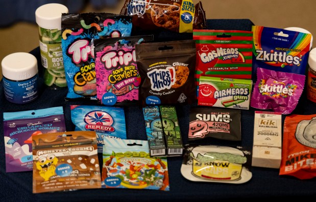 A selection of products available in stores that mimic existing brands are on display on April 11, 2024, at the Illinois State Capitol in Springfield as the Cannabis Business Association of Illinois and state legislators present bipartisan legislation regulating hemp consumer products and prohibiting synthetic THC intoxicants such as Delta-8. (Brian Cassella/Chicago Tribune)
